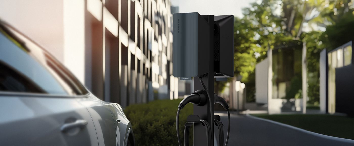 Teltonika pedestal EV charger beside a parked car at a residence