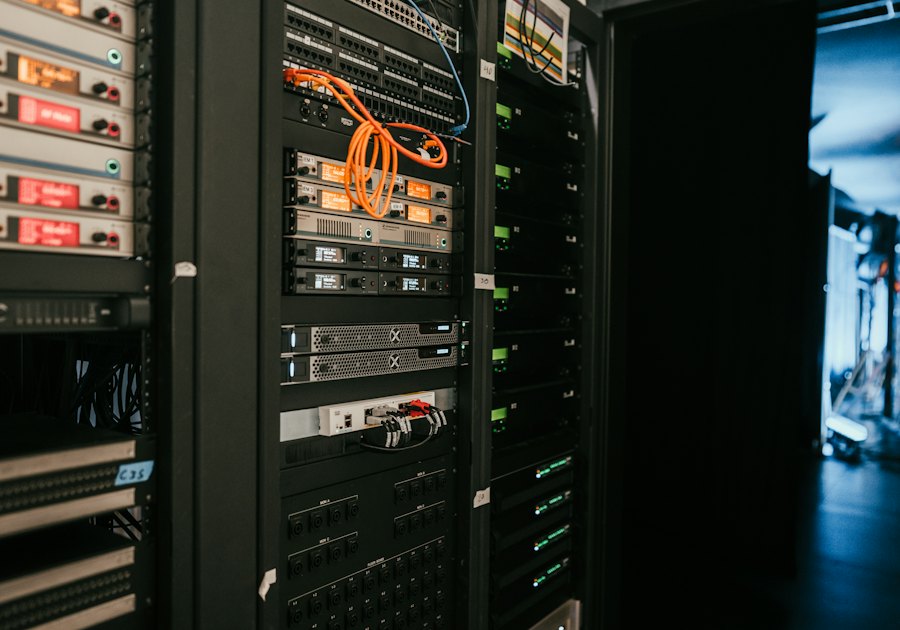 Technician working on network and monitoring equipment